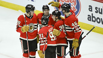 Mar 7, 2025; Chicago, Illinois, USA;  Chicago Blackhawks defenseman Wyatt Kaiser (44) (second from left)  celebrates with teammates after scoring a goal against the Utah Hockey Club during the second period  at the United Center. Mandatory Credit: Matt Marton-Imagn Images