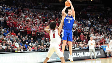 Former Drake Bulldogs guard Tucker DeVries (12) shoots against Washington State Cougars forward Jaylen Wells (0) in the second half in the first round of the 2024 NCAA Tournament at CHI Health Center Omaha.