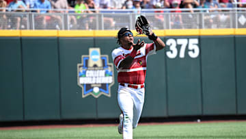 Jun 15, 2025; Omaha, Neb, USA;  Louisville Cardinals left fielder Zion Rose (32) makes an catch on the run against the Arizona Wildcats during the eighth inning at Charles Schwab Field. Mandatory Credit: Steven Branscombe-Imagn Images