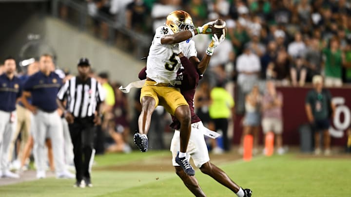 Aug 31, 2024; College Station, Texas, USA; Notre Dame Fighting Irish wide receiver Beaux Collins (5) catches a pass as Texas A&M Aggies defensive back Dashawn Fillmore (26) attempts to break up the play in the fourth quarter at Kyle Field. Mandatory Credit: Maria Lysaker-Imagn Images