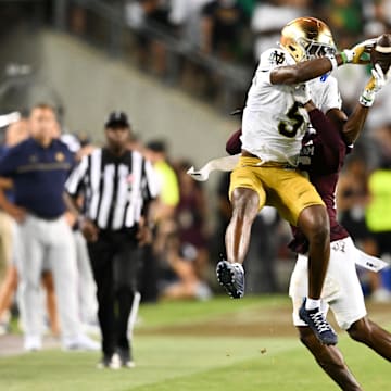 Aug 31, 2024; College Station, Texas, USA; Notre Dame Fighting Irish wide receiver Beaux Collins (5) catches a pass as Texas A&M Aggies defensive back Dashawn Fillmore (26) attempts to break up the play in the fourth quarter at Kyle Field.