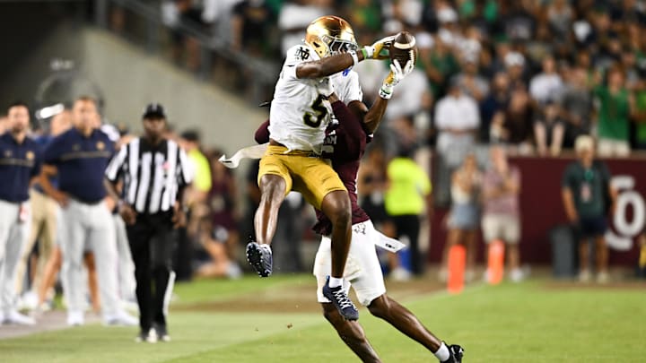 Aug 31, 2024; College Station, Texas, USA; Notre Dame Fighting Irish wide receiver Beaux Collins (5) catches a pass as Texas A&M Aggies defensive back Dashawn Fillmore (26) attempts to break up the play in the fourth quarter at Kyle Field.