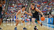 Mar 23, 2025; Raleigh, NC, USA; Connecticut Huskies forward Liam McNeeley (30) drives to the basket during the second half against Florida Gators guard Walter Clayton Jr. (1) in the second round of the NCAA Tournament at Lenovo Center. Mandatory Credit: Zachary Taft-Imagn Images