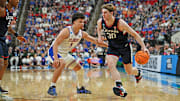 Mar 23, 2025; Raleigh, NC, USA; Connecticut Huskies forward Liam McNeeley (30) drives to the basket during the second half against Florida Gators guard Walter Clayton Jr. (1) in the second round of the NCAA Tournament at Lenovo Center. Mandatory Credit: Zachary Taft-Imagn Images