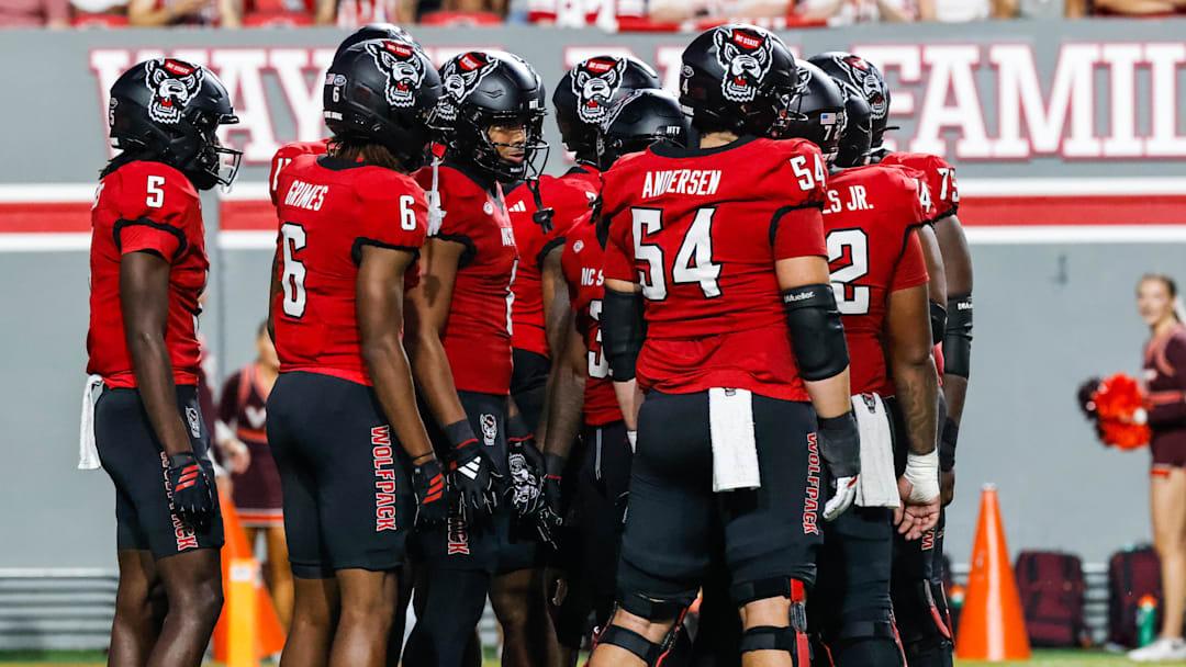 Sep 27, 2025; Raleigh, North Carolina, USA;  North Carolina State Wolfpack huddle during the first half of the game against Virginia Tech Hokies at Carter-Finley Stadium. Mandatory Credit: Jaylynn Nash-Imagn Images