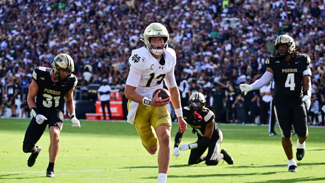 Sep 14, 2024; West Lafayette, Indiana, USA; Notre Dame Fighting Irish quarterback Riley Leonard (13) runs the ball in for a touchdown against the Purdue Boilermakers during the second quarter at Ross-Ade Stadium. Mandatory Credit: Marc Lebryk-Imagn Images