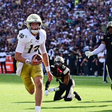 Sep 14, 2024; West Lafayette, Indiana, USA; Notre Dame Fighting Irish quarterback Riley Leonard (13) runs the ball in for a touchdown against the Purdue Boilermakers during the second quarter at Ross-Ade Stadium. Mandatory Credit: Marc Lebryk-Imagn Images