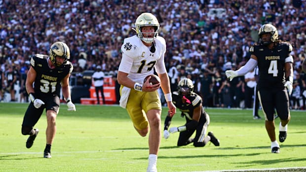 Notre Dame Fighting Irish quarterback Riley Leonard (13) runs the ball in for a touchdown against the Purdue Boilermakers dur