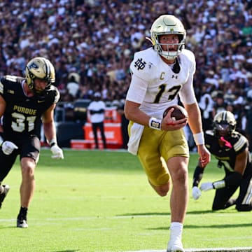 Sep 14, 2024; West Lafayette, Indiana, USA; Notre Dame Fighting Irish quarterback Riley Leonard (13) runs the ball in for a touchdown against the Purdue Boilermakers during the second quarter at Ross-Ade Stadium. Mandatory Credit: Marc Lebryk-Imagn Images