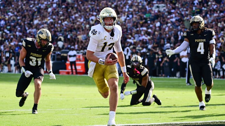 Sep 14, 2024; West Lafayette, Indiana, USA; Notre Dame Fighting Irish quarterback Riley Leonard (13) runs the ball in for a touchdown against the Purdue Boilermakers during the second quarter at Ross-Ade Stadium. Mandatory Credit: Marc Lebryk-Imagn Images