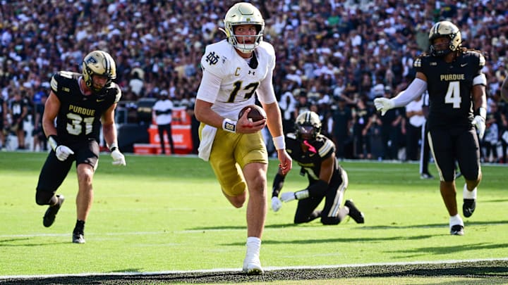 Sep 14, 2024; West Lafayette, Indiana, USA; Notre Dame Fighting Irish quarterback Riley Leonard (13) runs the ball in for a touchdown against the Purdue Boilermakers during the second quarter at Ross-Ade Stadium.