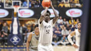 Mar 8, 2025; Morgantown, West Virginia, USA; UCF Knights center Moustapha Thiam (52) shoots a free throw during the second half .a2. at WVU Coliseum. Mandatory Credit: Ben Queen-Imagn Images