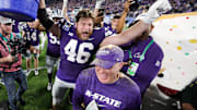 Dec 28, 2023; Orlando, FL, USA;  Kansas State Wildcats head coach Chris Klieman is congratulated by Kansas State Wildcats defensive end Jace Friesen (46) after beating North Carolina State Wolfpack in the Pop-Tarts bowl at Camping World Stadium. Mandatory Credit: Nathan Ray Seebeck-Imagn Images