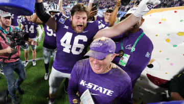 Dec 28, 2023; Orlando, FL, USA;  Kansas State Wildcats head coach Chris Klieman is congratulated by Kansas State Wildcats defensive end Jace Friesen (46) after beating North Carolina State Wolfpack in the Pop-Tarts bowl at Camping World Stadium. Mandatory Credit: Nathan Ray Seebeck-USA TODAY Sports