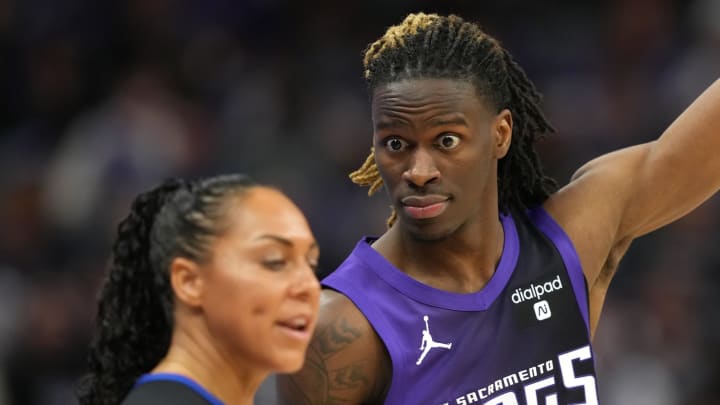 Mar 10, 2024; Sacramento, California, USA; Sacramento Kings guard Keon Ellis (right) argues with referee Sha’Rae Mitchell (left) during the third quarter against the Houston Rockets at Golden 1 Center. Mandatory Credit: Darren Yamashita-USA TODAY Sports