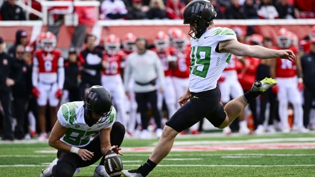 Oregon Ducks kicker Camden Lewis (49) kicks a PAT against the Utah Utes 