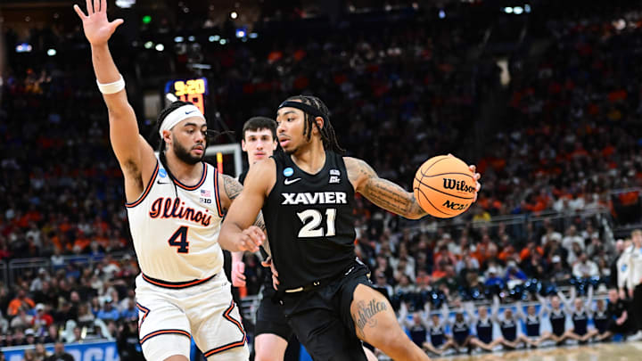Mar 21, 2025; Milwaukee, WI, USA: Xavier Musketeers guard Dante Maddox Jr. (21) drives to the hoop past Illinois Fighting Illini guard Kylan Boswell (4) during the first half at Fiserv Forum. Mandatory Credit: Benny Sieu-Imagn Images Mar 21, 2025; Milwaukee, WI, USA: Xavier Musketeers guard Dante Maddox Jr. (21) drives to the hoop past Illinois Fighting Illini guard Kylan Boswell (4) during the first half at Fiserv Forum. Mandatory Credit: Benny Sieu-Imagn Images