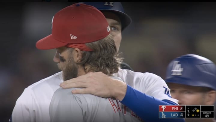 Los Angeles Dodgers star Freddie Freeman embraces Philadelphia Phillies slugger Bryce Harper following Freeman's third inning single.