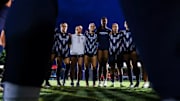 The Arizona soccer team huddled together before the stater of a match.