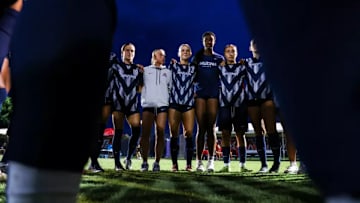 The Arizona soccer team huddled together before a match 