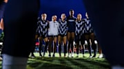 The Arizona soccer team huddled together before the start of a match.