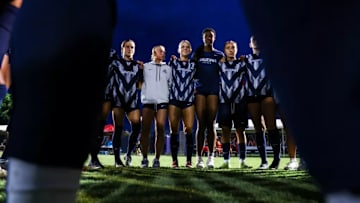 The Arizona soccer team huddled together before the start of a match.