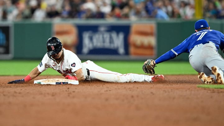 Aug 27, 2024; Boston, Massachusetts, USA; Boston Red Sox shortstop David Hamilton (70) steals second base against Toronto Blue Jays third baseman Will Wagner (7) during the fifth inning at Fenway Park. Mandatory Credit: Brian Fluharty-USA TODAY Sports