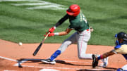 Jul 8, 2023; Seattle, Washington, USA; National League Futures designated hitter Justin Crawford (13) of the Philadelphia Phillies hits an RBI sacrifice fly against the American League during the second inning of the All Star-Futures game at T-Mobile Park.