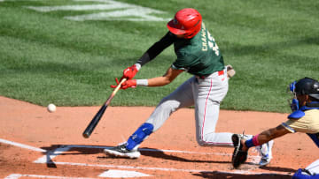 Jul 8, 2023; Seattle, Washington, USA; National League Futures designated hitter Justin Crawford (13) of the Philadelphia Phillies hits an RBI sacrifice fly against the American League during the second inning of the All Star-Futures game at T-Mobile Park. 