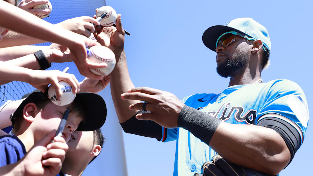 Miami Marlins second baseman Otto Lopez (6) signs autographs at spring training. 