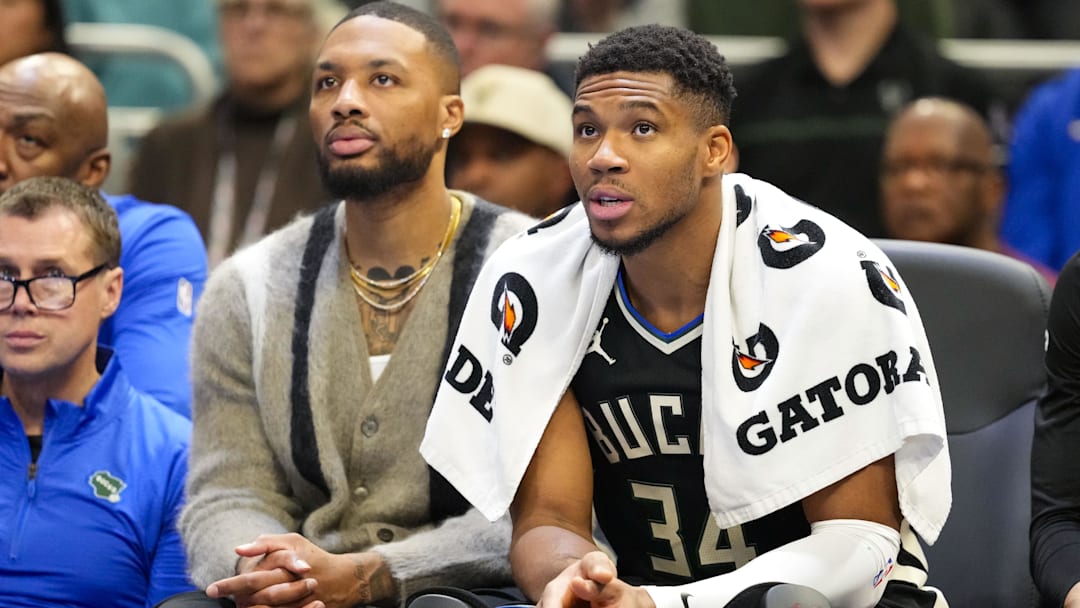 Nov 12, 2024; Milwaukee, Wisconsin, USA;  Milwaukee Bucks forward Giannis Antetokounmpo (34) sits with guard Damian Lillard on the bench during the fourth quarter against the Toronto Raptors at Fiserv Forum. Mandatory Credit: Jeff Hanisch-Imagn Images