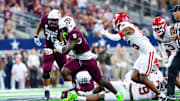 Sep 28, 2024; Arlington, Texas, USA;  Texas A&M Aggies running back Le'Veon Moss (8) runs with the ball as Arkansas Razorbacks defensive back Jaheim Singletary (15) defends during the second half at AT&T Stadium. Mandatory Credit: Kevin Jairaj-Imagn Images