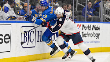 Jan 11, 2025; St. Louis, Missouri, USA;  St. Louis Blues right wing Alexey Toropchenko (13) and Columbus Blue Jackets defenseman Ivan Provorov (9)  battle for the puck during the second period at Enterprise Center. Mandatory Credit: Jeff Curry-Imagn Images