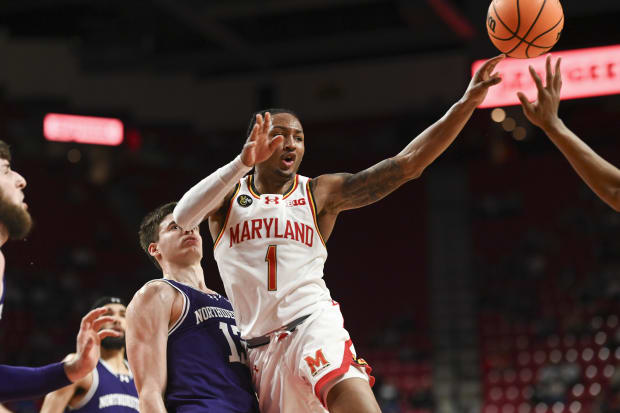 Feb 28, 2024; College Park, Maryland, USA;  Maryland Terrapins guard Jahmir Young (1) passes as Northwestern Wildcats guard Brooks Barnhizer (13) defends during the second half at Xfinity Center. Mandatory Credit: Tommy Gilligan-USA TODAY Sports