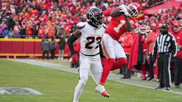 Jan 18, 2025; Kansas City, Missouri, USA; Kansas City Chiefs wide receiver Xavier Worthy (1) catches a pass as Houston Texans safety Eric Murray (23) defends during the first half of a 2025 AFC divisional round game at GEHA Field at Arrowhead Stadium. Mandatory Credit: Denny Medley-Imagn Images