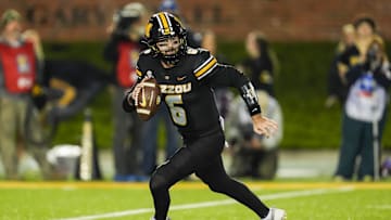 Nov 9, 2024; Columbia, Missouri, USA; Missouri Tigers quarterback Drew Pyne (6) rolls out to pass during the second half against the Oklahoma Sooners at Faurot Field at Memorial Stadium. Mandatory Credit: Jay Biggerstaff-Imagn Images