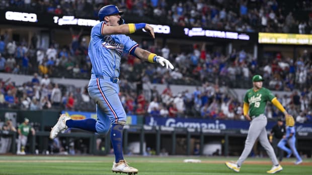 Texas Rangers slugger Josh Jung waves his walk-off home run over the fence.