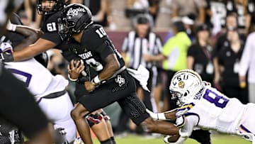 Oct 26, 2024; College Station, Texas, USA; Texas A&M Aggies quarterback Marcel Reed (10) runs the ball in the fourth quarter as LSU Tigers safety Major Burns (8) lunges to attempt a tackle at Kyle Field. Mandatory Credit: Maria Lysaker-Imagn Images. 
