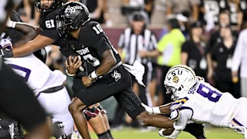 Oct 26, 2024; College Station, Texas, USA; Texas A&M Aggies quarterback Marcel Reed (10) runs the ball in the fourth quarter as LSU Tigers safety Major Burns (8) lunges to attempt a tackle at Kyle Field. Mandatory Credit: Maria Lysaker-Imagn Images. 