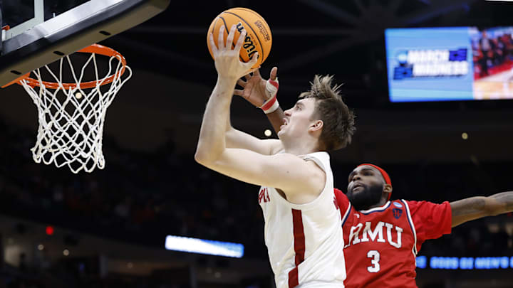 Mar 21, 2025; Cleveland, OH, USA; Alabama Crimson Tide forward Grant Nelson (4) goes to the basket defended by Robert Morris Colonials guard Amarion Dickerson (3) in the second half  during the NCAA Tournament First Round at Rocket Arena. Mandatory Credit: Rick Osentoski-Imagn Images