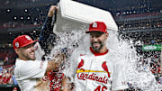 Sep 11, 2024; St. Louis, Missouri, USA;  St. Louis Cardinals first baseman Paul Goldschmidt (46) is doused with water by center fielder Michael Siani (63) and teammates after hitting the go ahead one run double in the eighth inning in a victory over the Cincinnati Reds at Busch Stadium. Mandatory Credit: Jeff Curry-Imagn Images