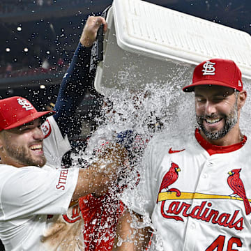 Sep 11, 2024; St. Louis, Missouri, USA;  St. Louis Cardinals first baseman Paul Goldschmidt (46) is doused with water by center fielder Michael Siani (63) and teammates after hitting the go ahead one run double in the eighth inning in a victory over the Cincinnati Reds at Busch Stadium. Mandatory Credit: Jeff Curry-Imagn Images