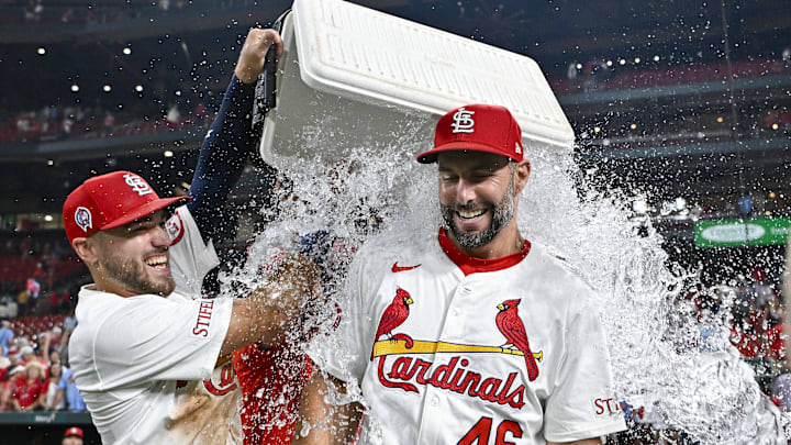 Sep 11, 2024; St. Louis, Missouri, USA;  St. Louis Cardinals first baseman Paul Goldschmidt (46) is doused with water by center fielder Michael Siani (63) and teammates after hitting the go ahead one run double in the eighth inning in a victory over the Cincinnati Reds at Busch Stadium. Mandatory Credit: Jeff Curry-Imagn Images