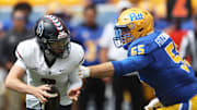 Aug 30, 2025; Pittsburgh, Pennsylvania, USA; Pittsburgh Panthers defensive lineman Sean FitzSimmons (55) pressures Duquesne Dukes quarterback Tyler Riddell (2) during the first quarter at Acrisure Stadium. Mandatory Credit: Charles LeClaire-Imagn Images
