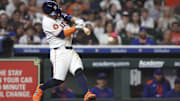 Houston Astros star Jose Altuve hits a single during the sixth inning against the New York Mets.