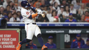 Houston Astros star Jose Altuve hits a single during the sixth inning against the New York Mets.