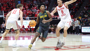 Jan 25, 2025; Salt Lake City, Utah, USA; Baylor Bears guard Robert Wright III (1) drives to the basket against Utah Utes forward Keanu Dawes (8) during the first half at Jon M. Huntsman Center. Mandatory Credit: Rob Gray-Imagn Images
