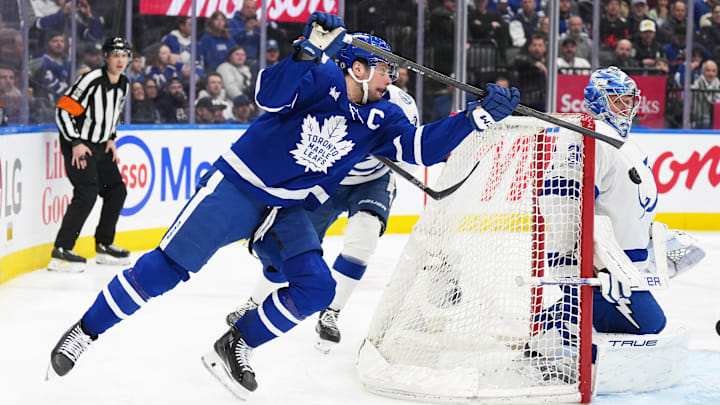 Jan 20, 2025; Toronto, Ontario, CAN; Toronto Maple Leafs center Auston Matthews (34) attempts a wrap around with the puck on Tampa Bay Lightning goaltender Jonas Johansson (31) during the third period at Scotiabank Arena. Mandatory Credit: Nick Turchiaro-Imagn Images