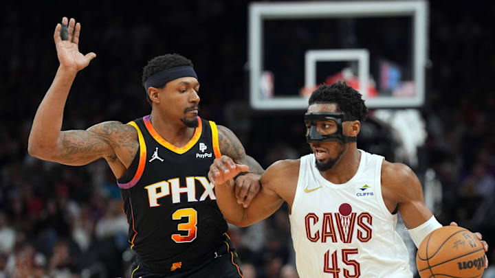 Apr 3, 2024; Phoenix, Arizona, USA; Cleveland Cavaliers guard Donovan Mitchell (45) dribbles against Phoenix Suns guard Bradley Beal (3) during the second half at Footprint Center. Mandatory Credit: Joe Camporeale-Imagn Images