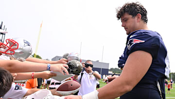 Aug 6, 2025; Foxborough, MA, USA; New England Patriots offensive tackle Will Campbell signs autographs after training camp at Gillette Stadium